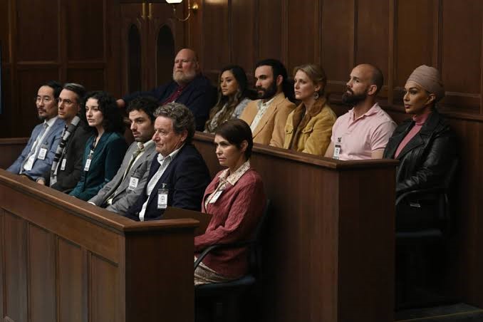 Still from a TV show depicting a jury sitting in a courtroom.  